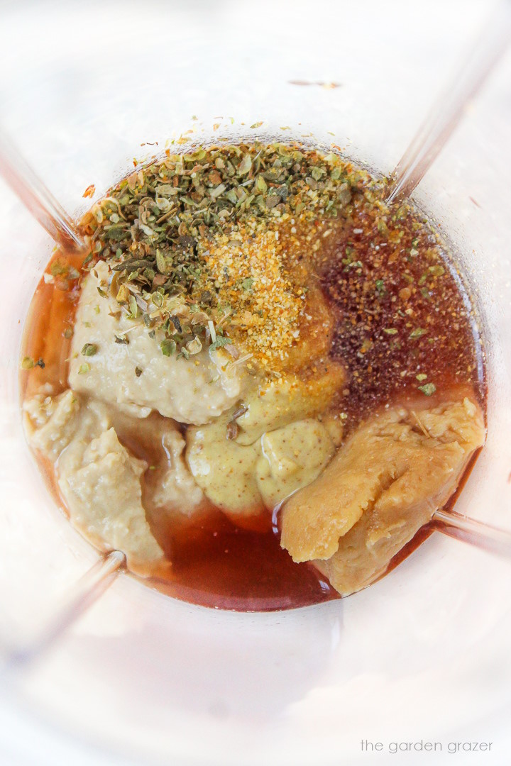 Overhead view of dressing ingredients in a blender before blending