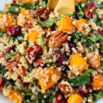 Close up view of vegan fall harvest quinoa salad on a white serving plate