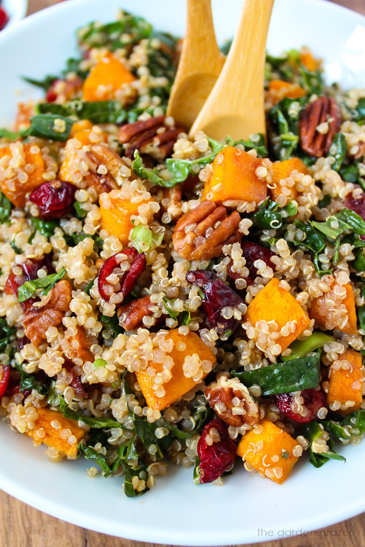 Close up view of vegan fall harvest quinoa salad on a white serving plate