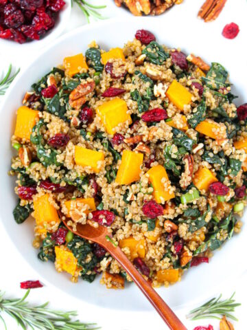 Fall harvest quinoa salad with kale and butternut squash in a white bowl