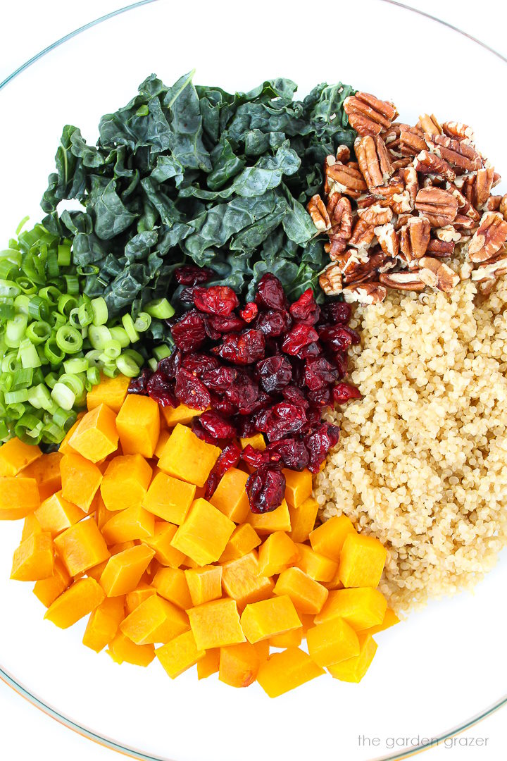 Overhead view of salad ingredients in a bowl before tossing together