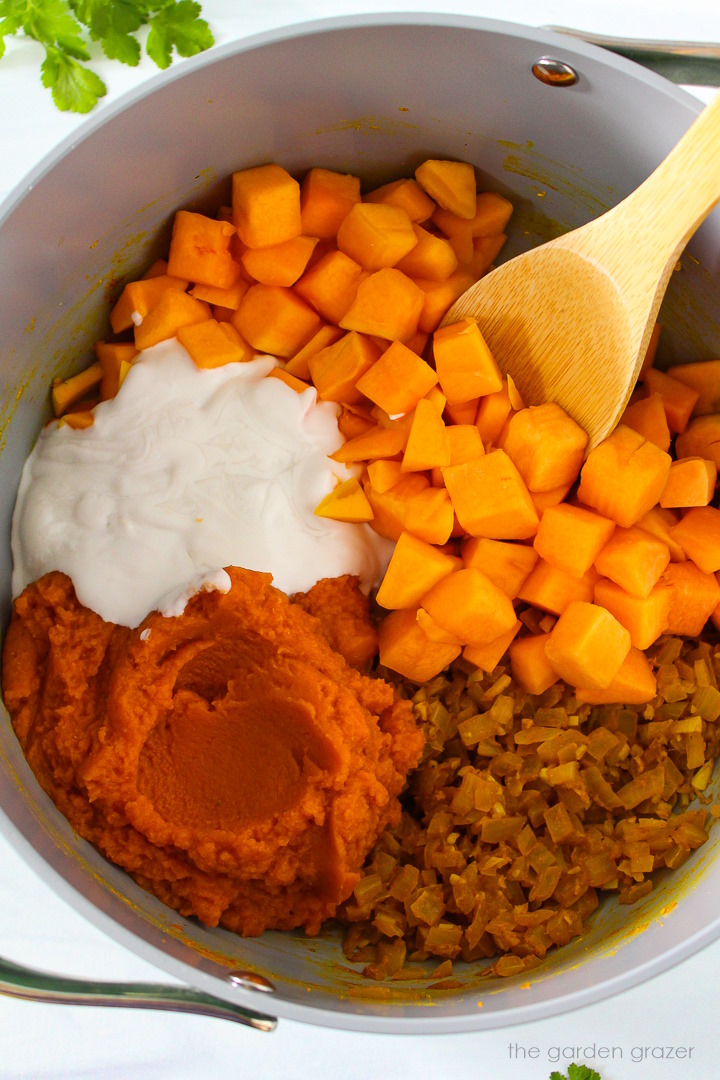 Overhead view of preparing soup ingredients in a large pot before mixing together