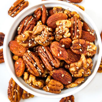 Savory tamari roasted nuts with sesame seeds in a small white bowl