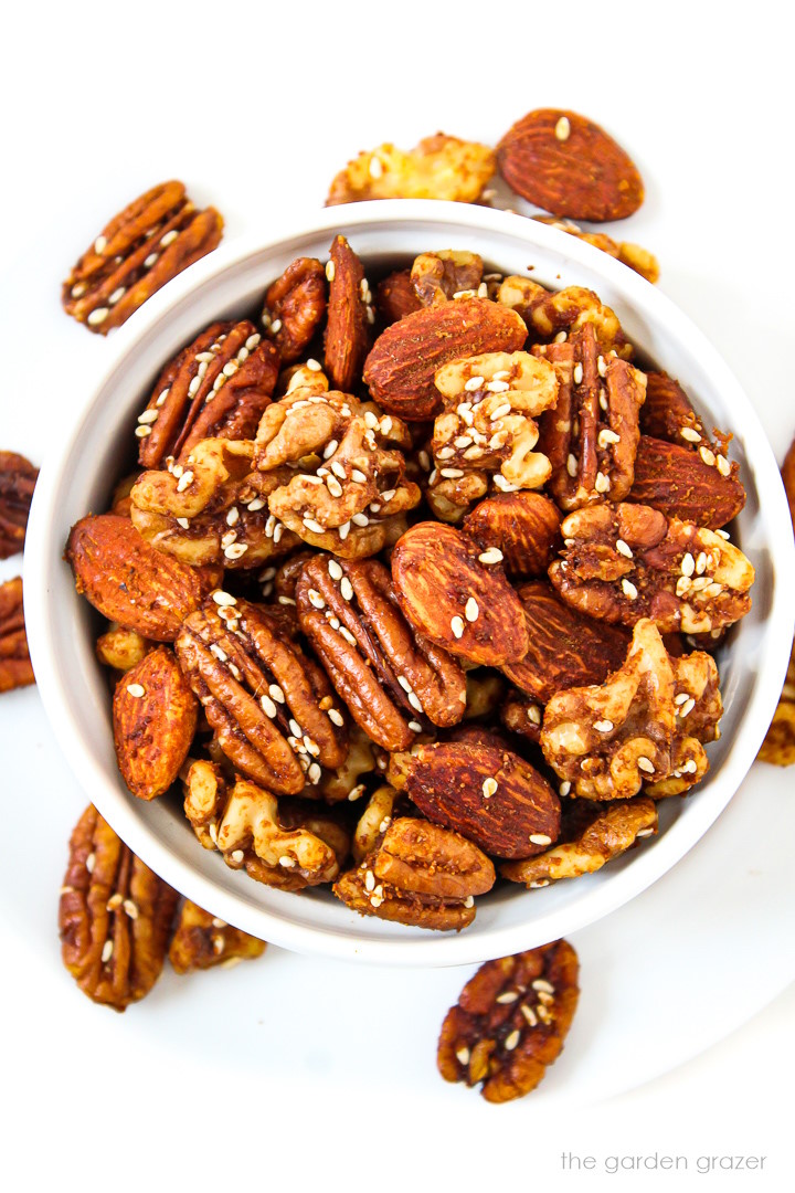 Savory tamari roasted nuts with sesame seeds in a small white bowl