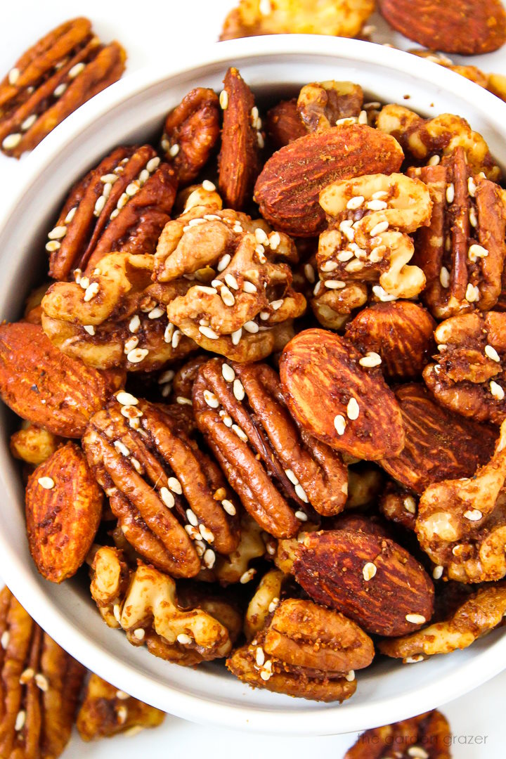 Close up view of tamari roasted nuts in a white bowl