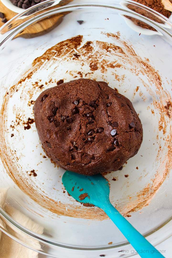 Overhead view of preparing cookie dough in a large mixing bowl with spatula