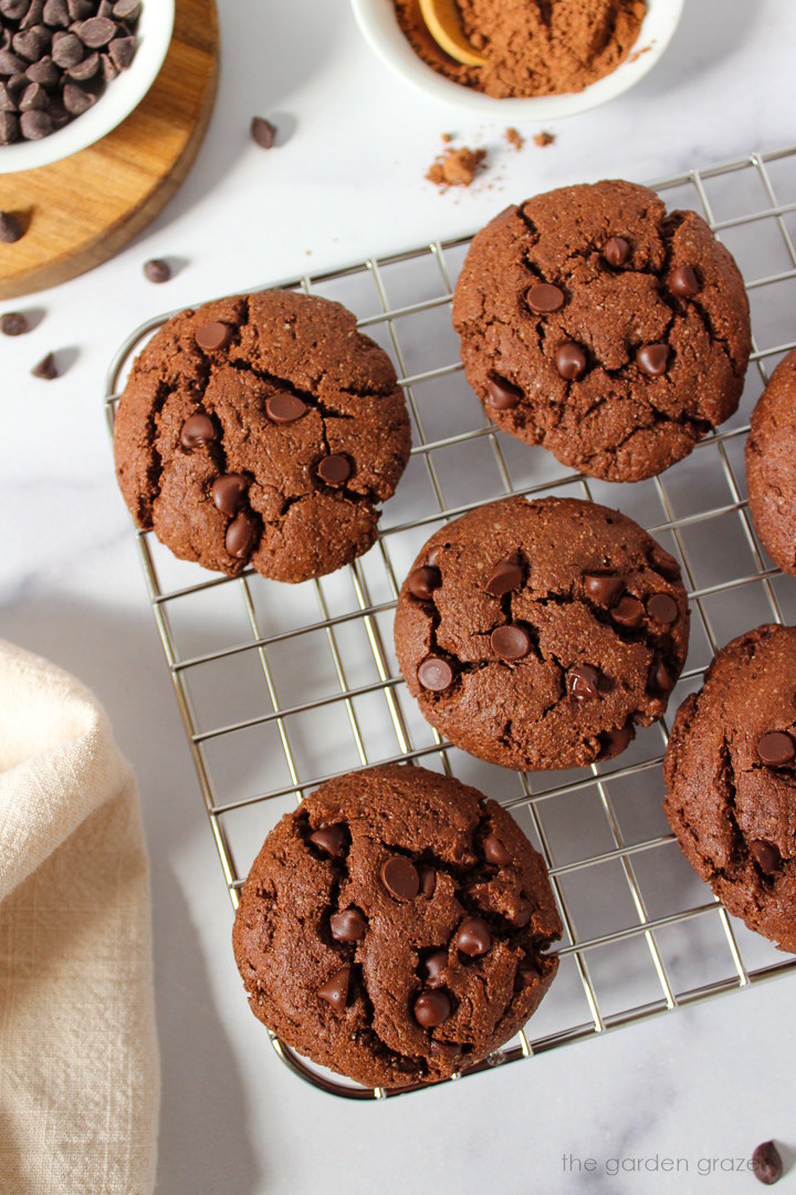 Overhead view of vegan chocolate cookies cooling on a rack after baking