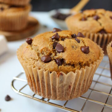 Vegan chocolate chip muffins on a cooling rack after baking
