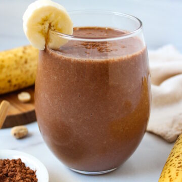 Chunky monkey smoothie with banana, peanut butter, and cocoa powder served in a glass