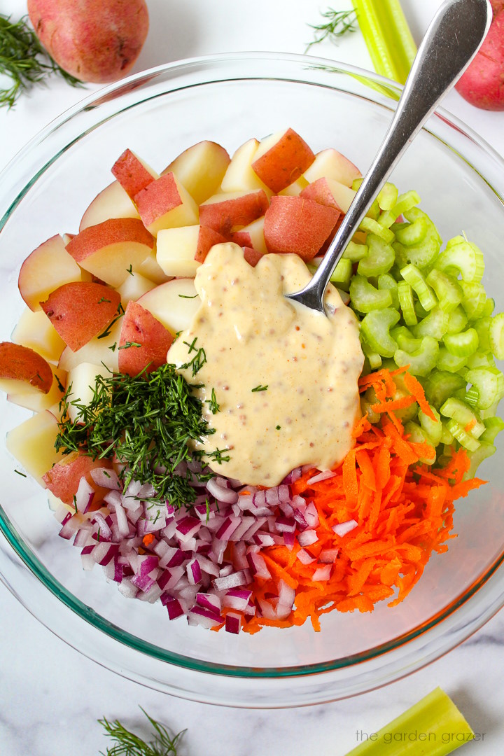 Overhead view of preparing ingredients in a large glass bowl before mixing together