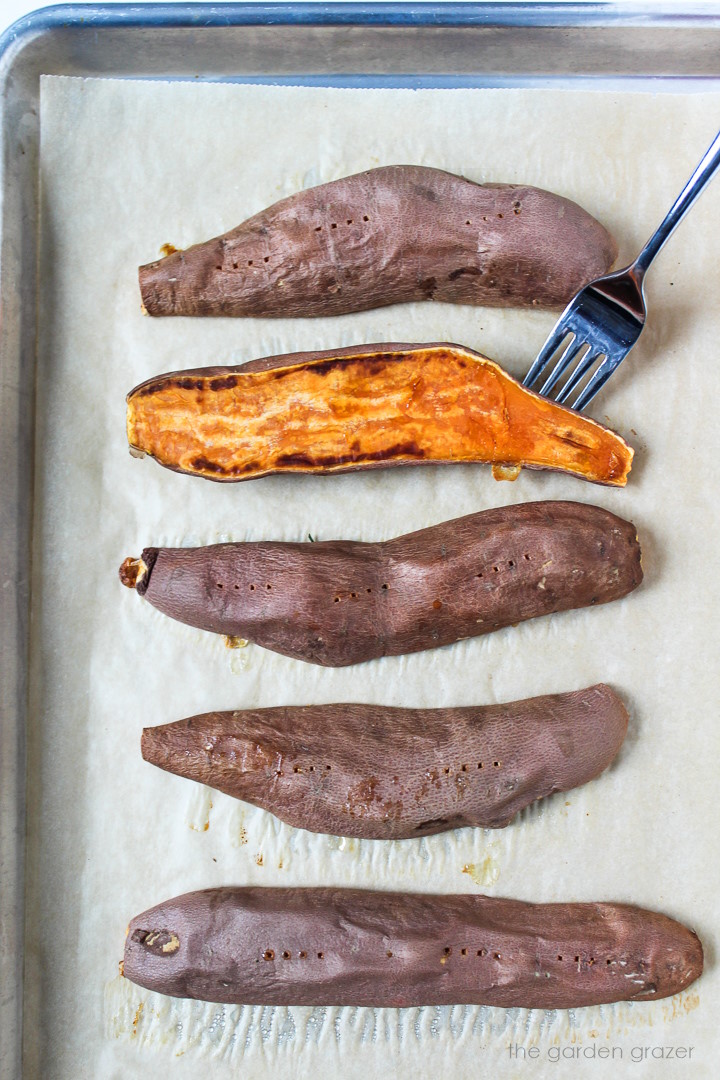 Sweet potato halves after roasting on a sheet pan
