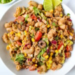 Taco pasta salad tossed in a creamy southwest dressing served in a white bowl