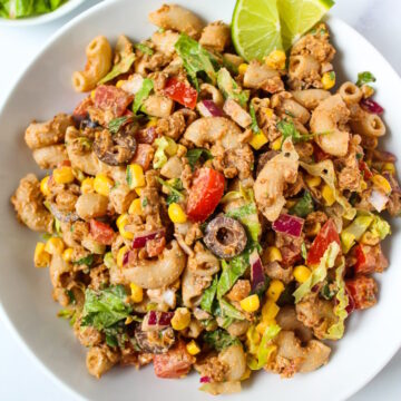 Taco pasta salad tossed in a creamy southwest dressing served in a white bowl