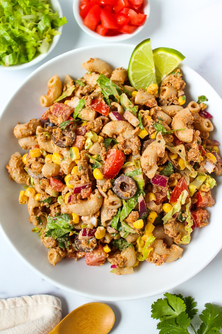 Taco pasta salad tossed in a creamy southwest dressing served in a white bowl
