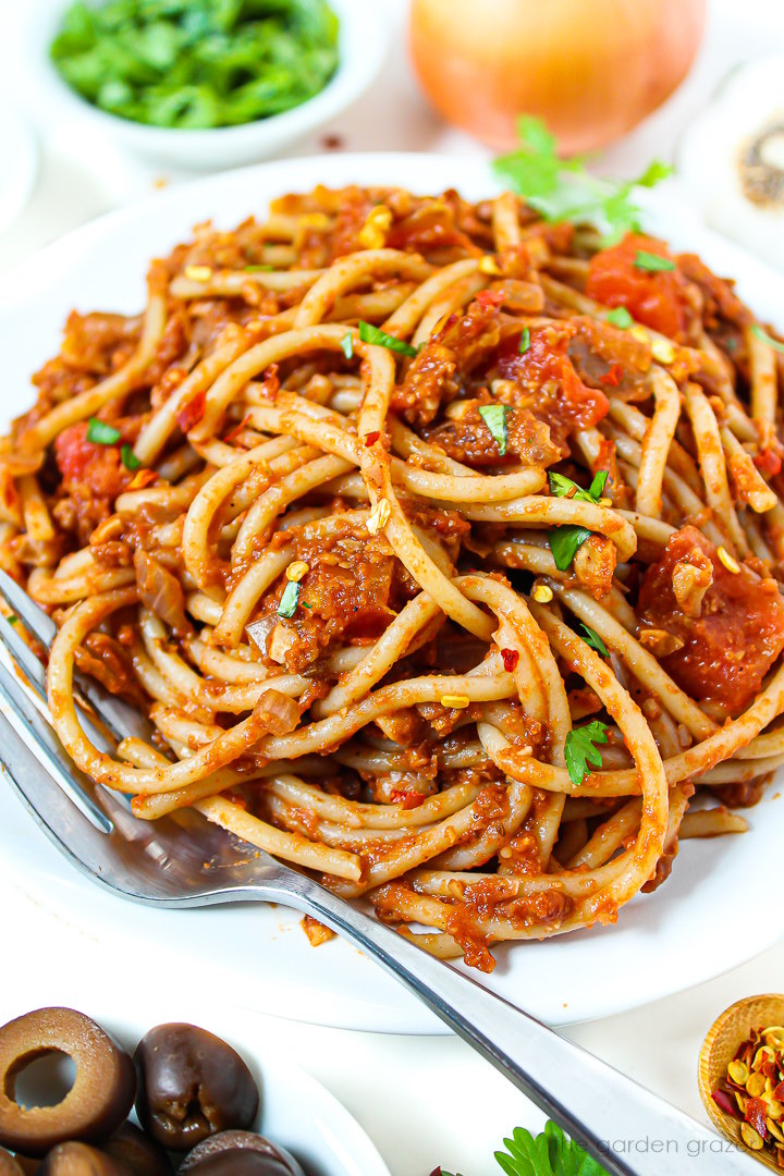 Taco spaghetti served on a white plate garnished with fresh cilantro