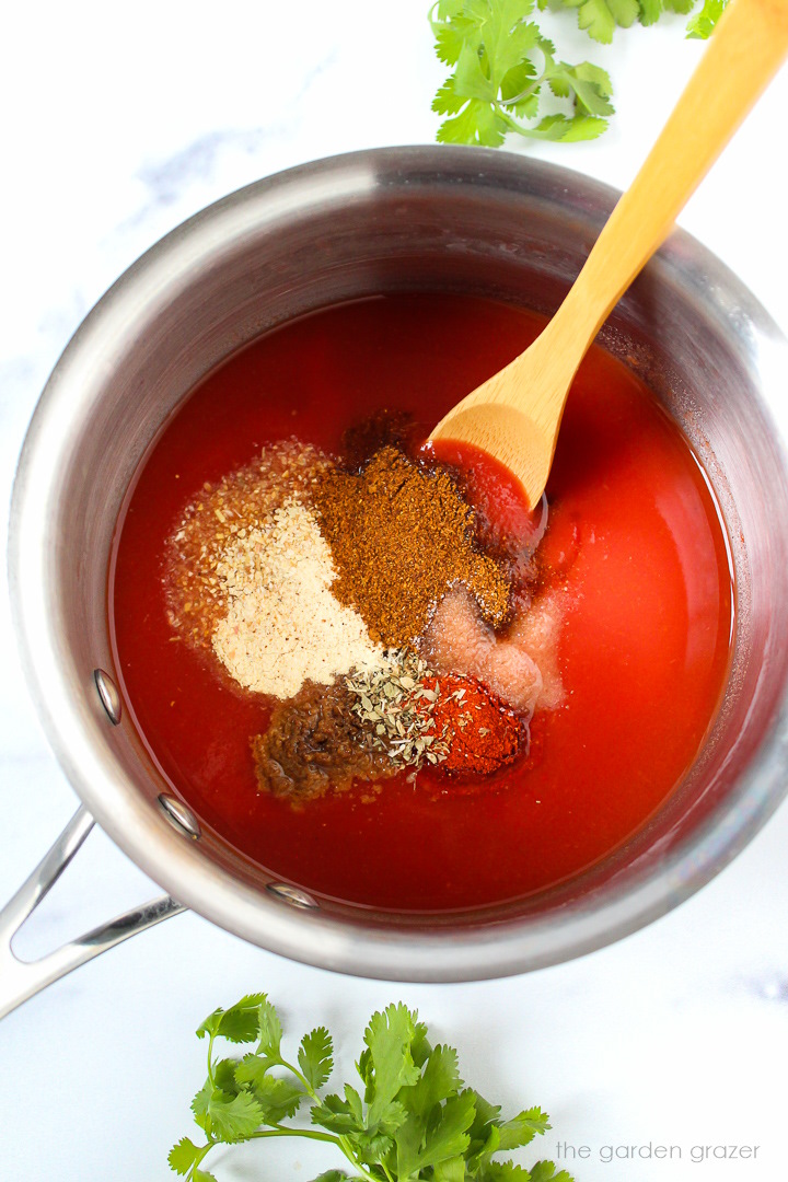 Preparing taco sauce ingredients in a small pot before cooking and mixing together