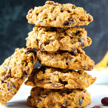 Vegan oatmeal raisin cookies stacked on top of each other