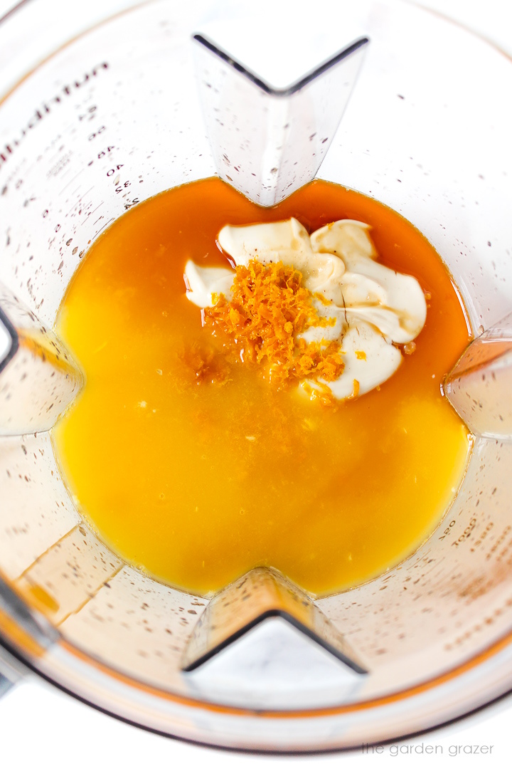 Overhead view of ice pop ingredients in a blender before blending together