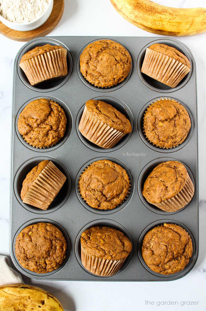Overhead view of vegan banana muffins in a muffin pan after baking
